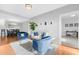 Bright living room with hardwood floors, comfy seating, and a view into the dining area at 250 Park W Ave # 701, Atlanta, GA 30313