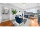 Living room with hardwood floors, a view of the balcony, and a half-bathroom at 250 Park W Ave # 701, Atlanta, GA 30313