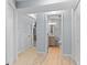 Basement hallway with light gray walls and vinyl flooring, leading to other rooms at 2339 Milstead Cir, Marietta, GA 30066