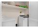 Laundry room with washer, dryer, and storage shelves at 2339 Milstead Cir, Marietta, GA 30066