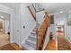 Light gray carpeted staircase with wooden railing and view into the kitchen at 2339 Milstead Cir, Marietta, GA 30066