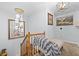 Upstairs hall with chaise lounge and stylish light fixture at 2339 Milstead Cir, Marietta, GA 30066