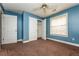 Bedroom with blue walls, carpet, and double door closet at 5399 Emily Cir, Ellenwood, GA 30294