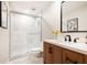 Updated bathroom featuring a walk-in shower, double vanity with wood cabinets, and neutral tile flooring at 15 Kings Tavern Nw Pl, Atlanta, GA 30318