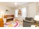 Charming Bedroom featuring a wooden crib, a cozy armchair, and colorful decor creating a playful atmosphere at 15 Kings Tavern Nw Pl, Atlanta, GA 30318