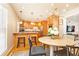 Bright dining area open to the kitchen, featuring a modern chandelier at 15 Kings Tavern Nw Pl, Atlanta, GA 30318