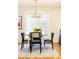 Bright dining area featuring a modern chandelier, round table, and stylish black chairs, perfect for intimate gatherings at 15 Kings Tavern Nw Pl, Atlanta, GA 30318