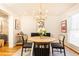 Elegant dining area with a round table and a view into the living room at 15 Kings Tavern Nw Pl, Atlanta, GA 30318