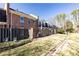 Charming townhome exterior showcasing brick facade, fenced patio and well-maintained landscaping at 15 Kings Tavern Nw Pl, Atlanta, GA 30318