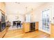 Open concept kitchen and dining area with a built-in wine cooler at 15 Kings Tavern Nw Pl, Atlanta, GA 30318