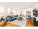 Bright living room with hardwood floors, modern furniture, and open dining area at 15 Kings Tavern Nw Pl, Atlanta, GA 30318