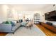 Spacious living room showcasing a sleek entertainment center and adjacent dining area at 15 Kings Tavern Nw Pl, Atlanta, GA 30318