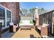 Cozy outdoor patio with wicker furniture, umbrella and brick siding provides an inviting space for relaxation at 15 Kings Tavern Nw Pl, Atlanta, GA 30318