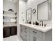 Bathroom featuring double vanity with stone countertop and framed mirrors, with plenty of storage at 33 Ponce De Leon Ne Ave # 203, Atlanta, GA 30308