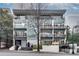 Modern building facade with multiple balconies and well-maintained landscaping at 33 Ponce De Leon Ne Ave # 203, Atlanta, GA 30308