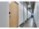 Hallway with textured walls, industrial ceiling with exposed pipes, and multiple apartment doors at 33 Ponce De Leon Ne Ave # 203, Atlanta, GA 30308