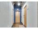 Apartment hallway with textured walls, three doors, and industrial style ceiling with exposed pipes at 33 Ponce De Leon Ne Ave # 203, Atlanta, GA 30308