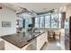 Modern kitchen island flows into a dining area, complemented by an open layout and natural light at 33 Ponce De Leon Ne Ave # 203, Atlanta, GA 30308