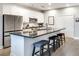 Bright kitchen featuring white cabinets, stainless appliances, granite counters, and an island with stools at 33 Ponce De Leon Ne Ave # 203, Atlanta, GA 30308