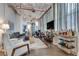 Spacious living room with industrial accents, a large sectional sofa, and city views at 33 Ponce De Leon Ne Ave # 203, Atlanta, GA 30308