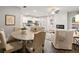 Open concept dining area with a rustic wooden table and six beige chairs at 5595 Hislop Lane # 77, Mableton, GA 30126