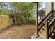 Small backyard with wooden stairs and a wooden fence at 66 Howell Ne St, Atlanta, GA 30312