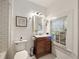 Clean bathroom with a brown vanity, hex tile floor, and window at 66 Howell Ne St, Atlanta, GA 30312