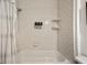 Updated bathroom with subway tile surround and convenient shower dispensers at 66 Howell Ne St, Atlanta, GA 30312