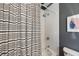 Clean bathroom with shower/tub combo and stylish striped shower curtain at 66 Howell Ne St, Atlanta, GA 30312