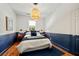 Stylish bedroom with a two-tone painted wall, hardwood floors, and a decorative pendant light at 66 Howell Ne St, Atlanta, GA 30312