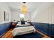 Bedroom with blue accent wall and hardwood floors at 66 Howell Ne St, Atlanta, GA 30312