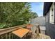 Wooden deck with small table and chair, overlooks treetops at 66 Howell Ne St, Atlanta, GA 30312