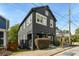 Charming two-story home with a dark exterior and well-maintained landscaping at 66 Howell Ne St, Atlanta, GA 30312