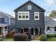 Well-maintained two-story house with dark exterior, featuring a front yard at 66 Howell Ne St, Atlanta, GA 30312