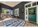Inviting front porch with ample seating, a stylish rug, and a freshly painted exterior at 66 Howell Ne St, Atlanta, GA 30312