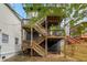 Two story house with wooden deck and stairs in the backyard at 66 Howell Ne St, Atlanta, GA 30312