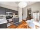 Open kitchen with gray cabinets, stainless appliances, and a cozy dining area at 66 Howell Ne St, Atlanta, GA 30312