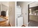 Convenient laundry area with stacked washer and dryer next to bathroom at 66 Howell Ne St, Atlanta, GA 30312