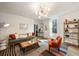 Spacious living room with a large sofa, comfortable armchair, and a wooden coffee table at 66 Howell Ne St, Atlanta, GA 30312