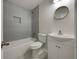 Updated bathroom with gray tile and white vanity at 170 Eldorado Dr, Carrollton, GA 30116