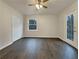 Spacious bedroom with wood-look floors, ceiling fan and private deck access at 170 Eldorado Dr, Carrollton, GA 30116