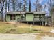 Green house with deck and surrounding trees at 170 Eldorado Dr, Carrollton, GA 30116