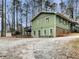 Green house with deck, surrounded by trees at 170 Eldorado Dr, Carrollton, GA 30116