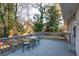 View of the back deck with a table and chairs surrounded by trees at 3448 Montreal Way, Tucker, GA 30084