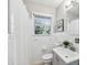 Charming bathroom features a bright window, white tile, and a neutral color palette for a clean feel at 3448 Montreal Way, Tucker, GA 30084