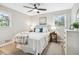 Bedroom features plush bedding, two windows, a ceiling fan, and cozy decor at 3448 Montreal Way, Tucker, GA 30084
