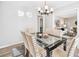 Dining room with sleek black table, upholstered chairs, and easy access to living room at 3448 Montreal Way, Tucker, GA 30084