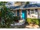 Close-up of a charming home's entrance with a bright blue door and decorative iron porch supports at 3448 Montreal Way, Tucker, GA 30084