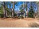 Exterior view of home with mature trees and a blue front door at 3448 Montreal Way, Tucker, GA 30084