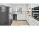 Modern kitchen with white cabinets, stainless steel appliances, and bright quartz countertops at 3448 Montreal Way, Tucker, GA 30084
